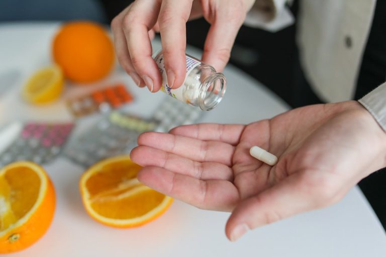 A person holding a white pill.